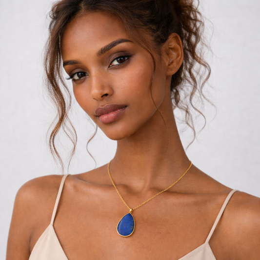 Lapis lazuli pendant necklace worn on model with beige top and gold chain