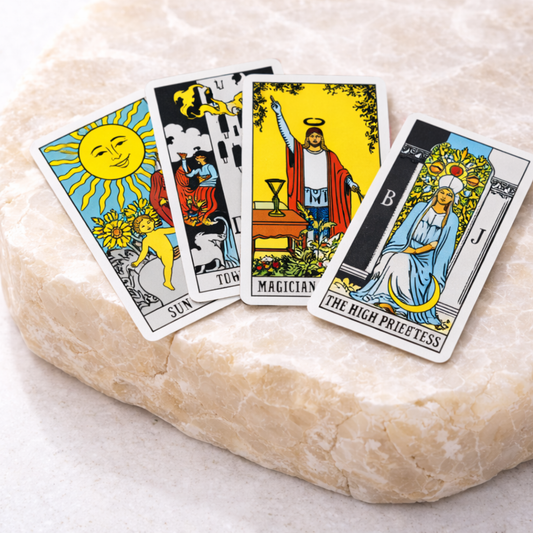 Rider Waite tarot cards fanned on stone surface