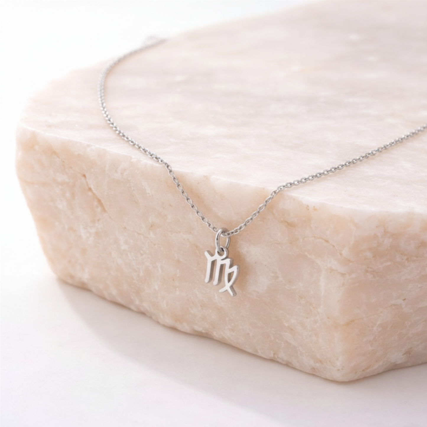 Virgo zodiac necklace silver pendant on beige stone slab