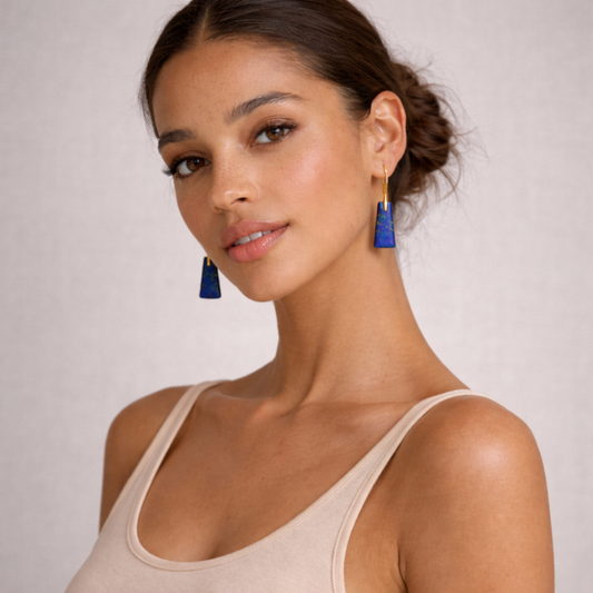 Woman wearing lapis lazuli cut stone earrings