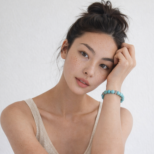 Woman wearing turquoise bead bracelet with silver spacer beads