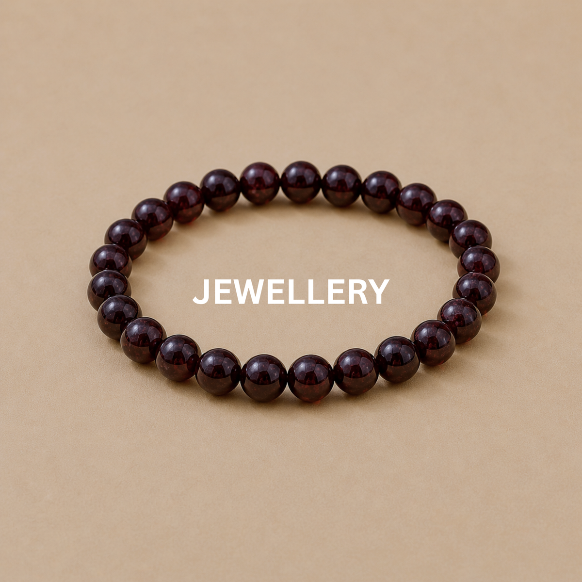 Garnet crystal bracelet on beige stone slab jewellery display