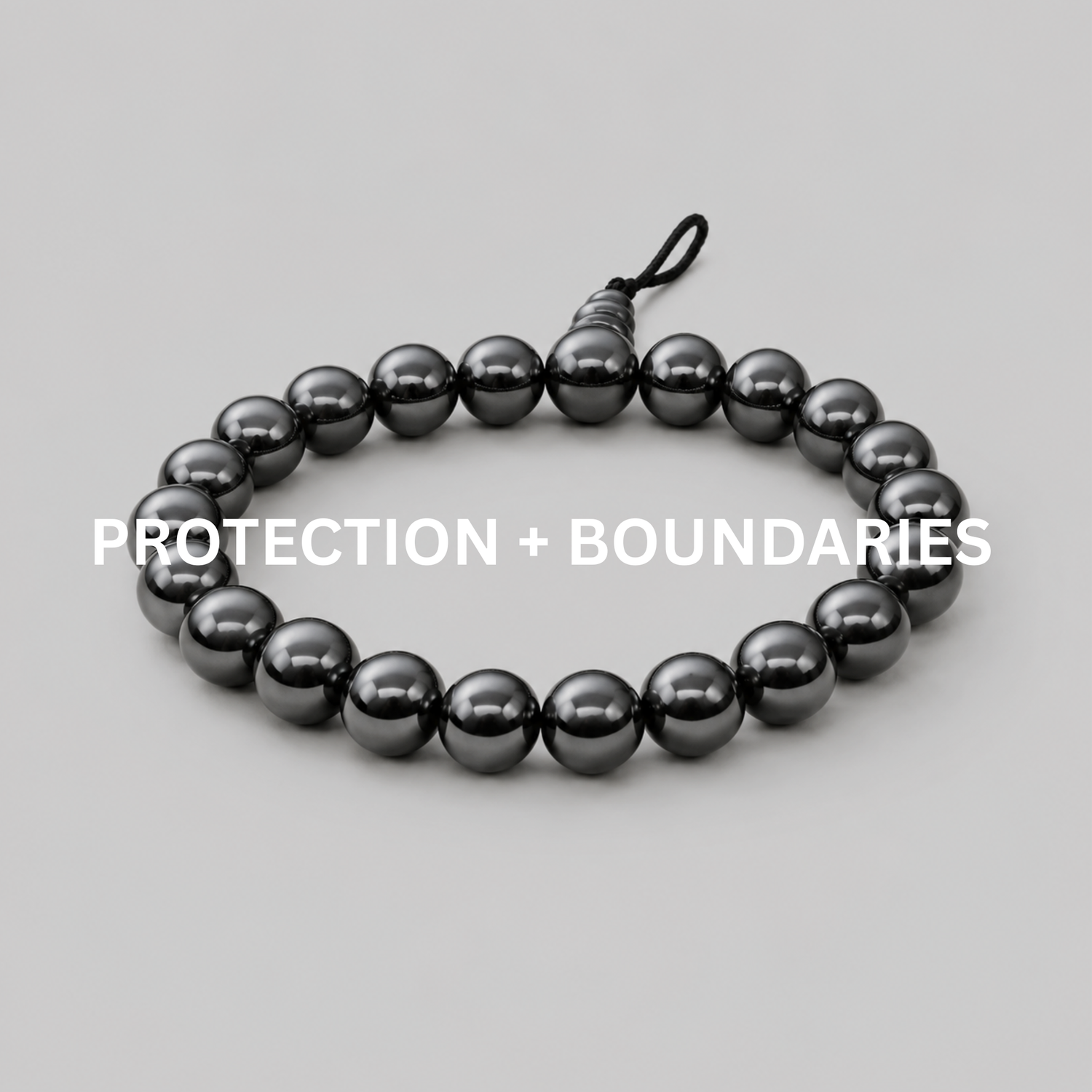 Protection + Boundaries bracelet collection image with hematite bead bracelet on neutral background