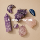 Use:  **Amethyst, rose quartz and blue crystals arranged on a warm beige background for Shop by Intention.**