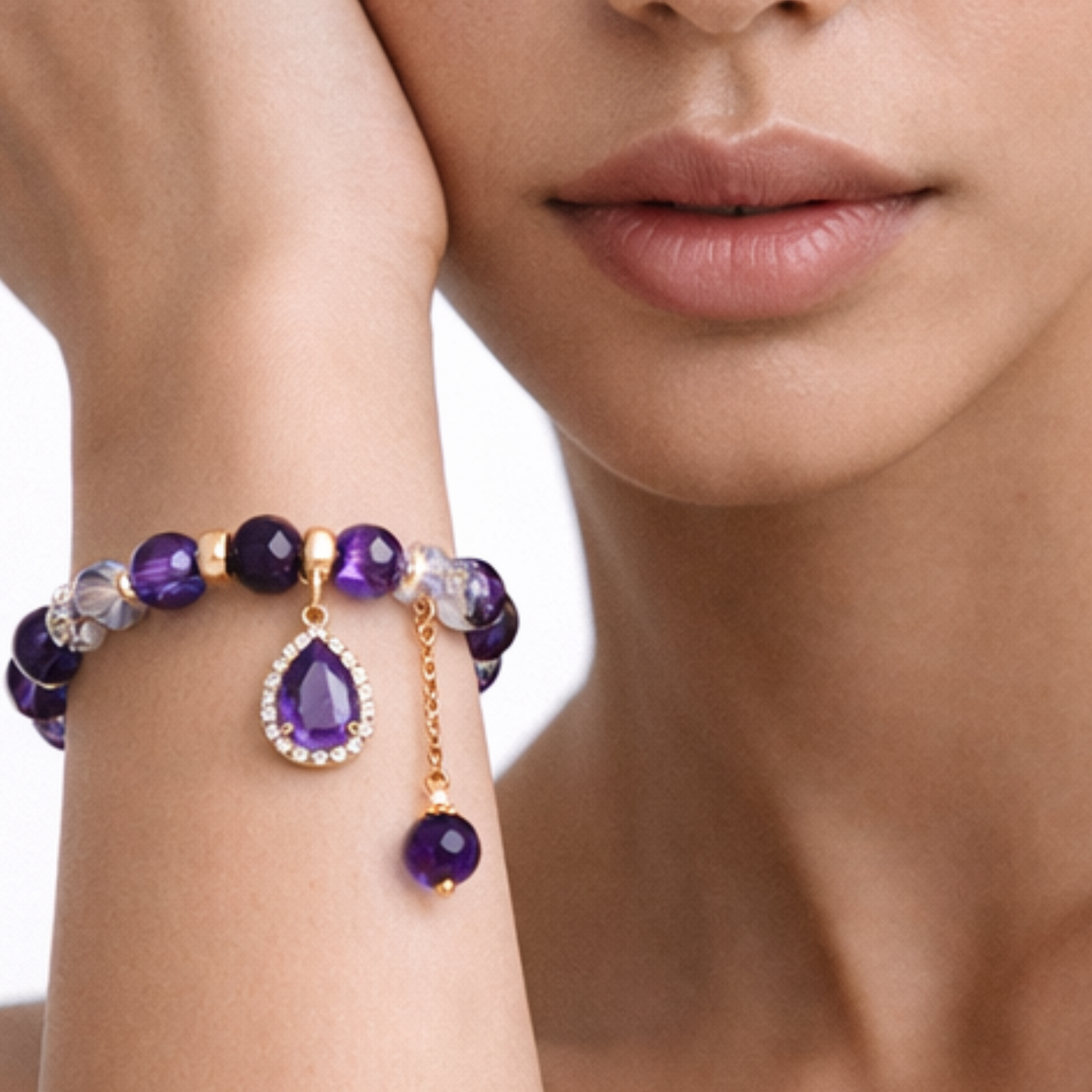 Amethyst pendant bracelet worn on wrist with gold charm and purple crystal beads