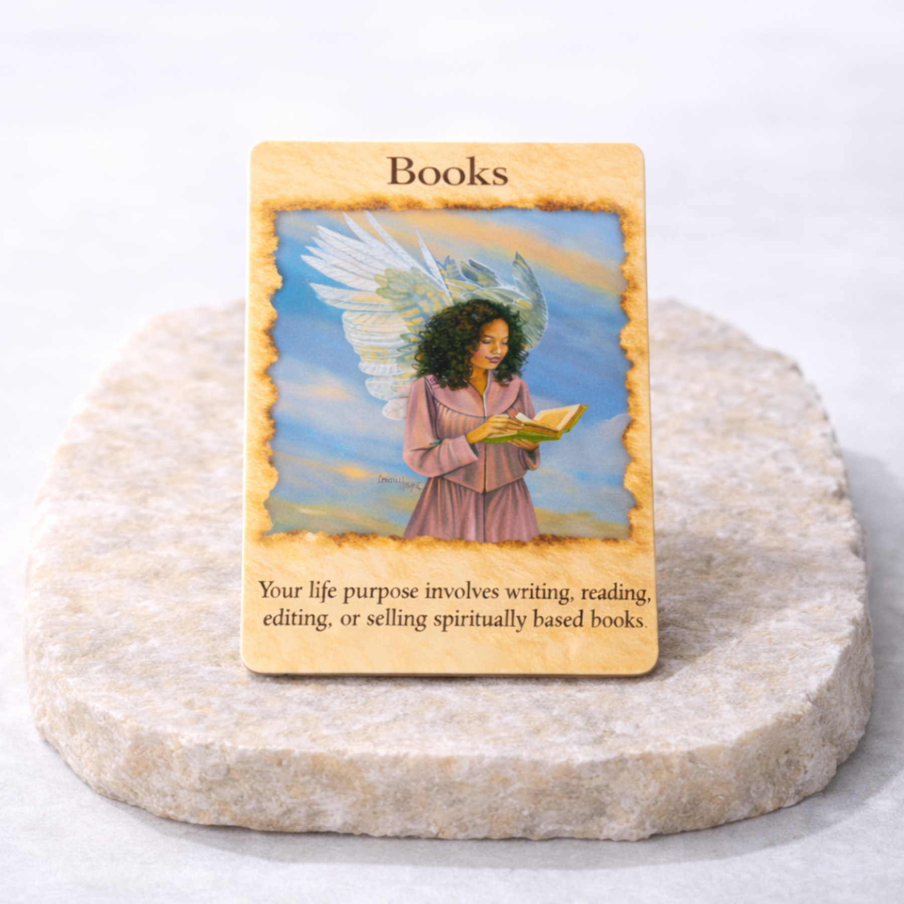 Angel oracle cards Books card close up on beige stone slab