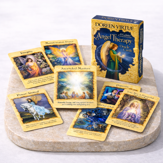 Angel oracle cards Doreen Virtue Angel Therapy deck with multiple cards spread on beige stone slab