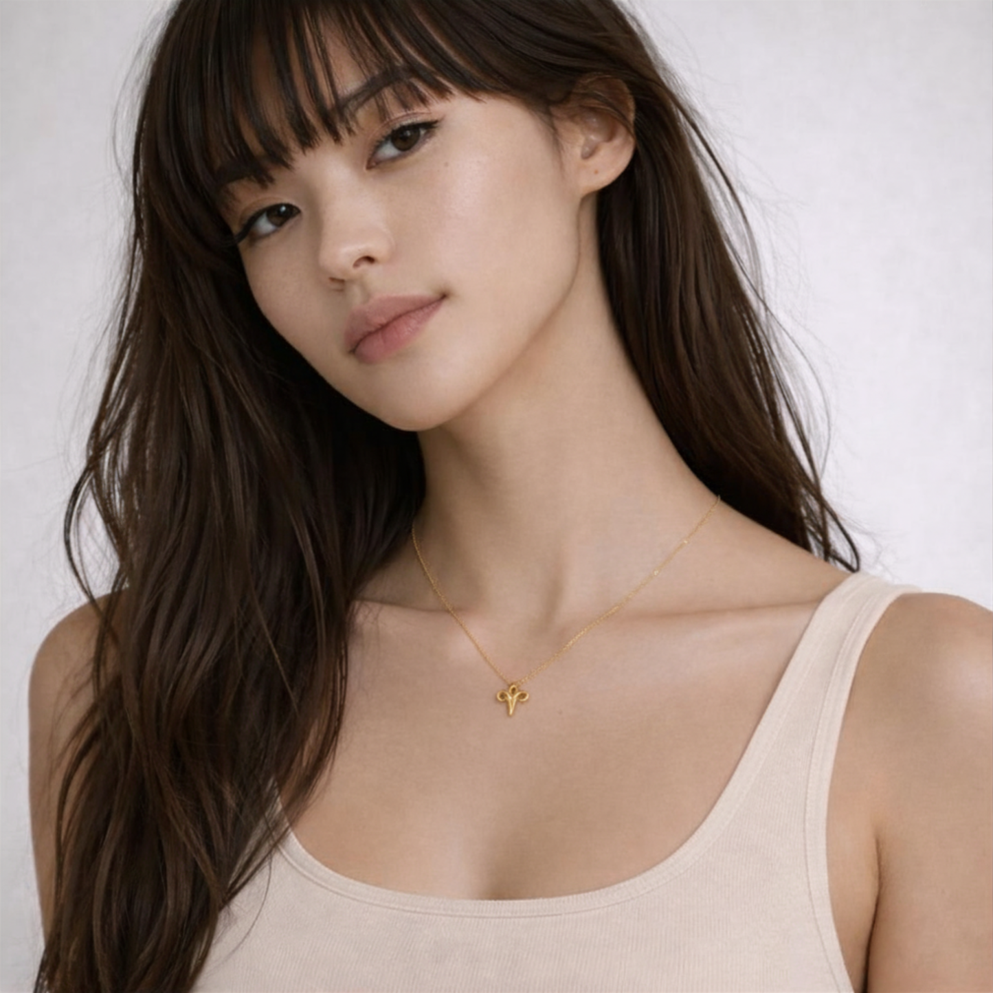 Aries necklace gold close up on model showing pendant on chest
