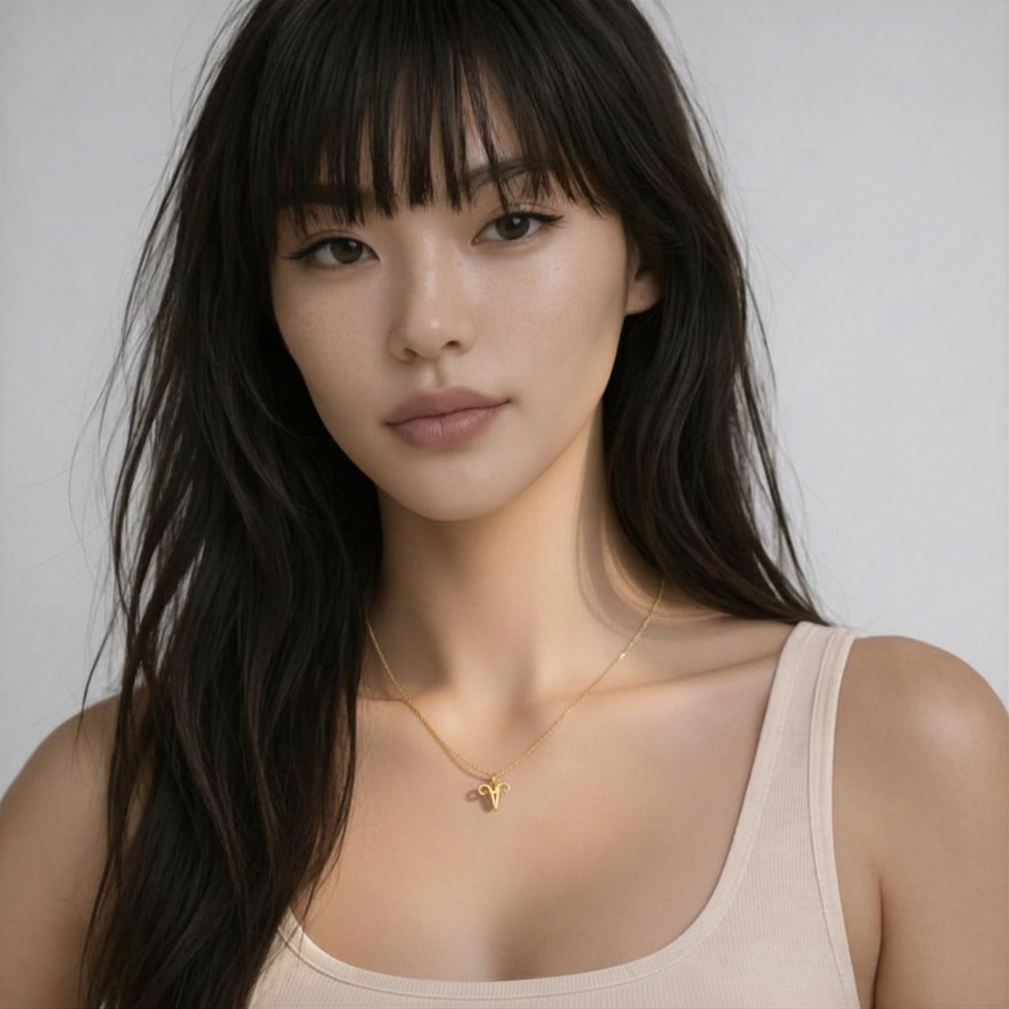 Aries necklace gold worn on model with beige top and gold chain