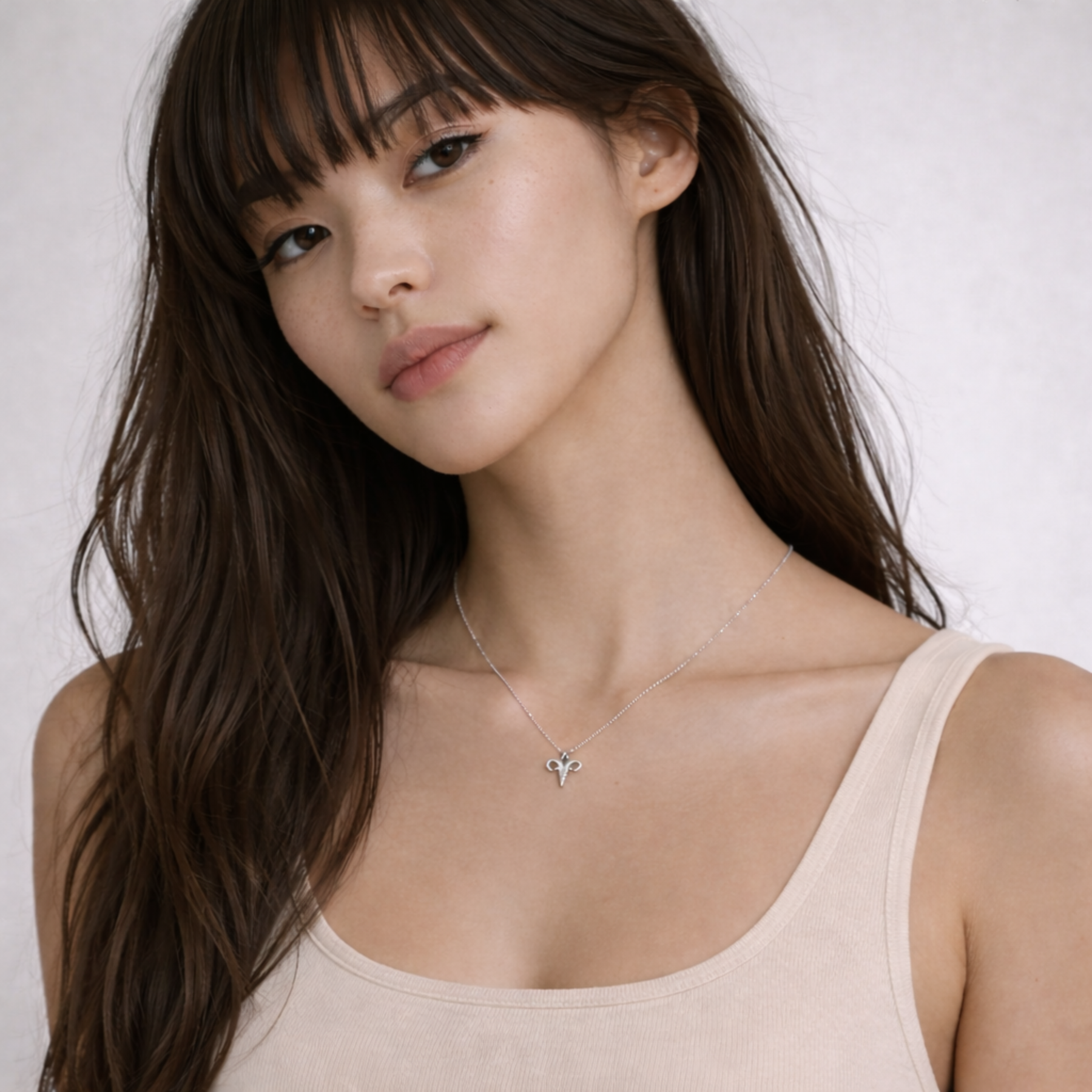 Aries necklace silver close up on model showing pendant on chest