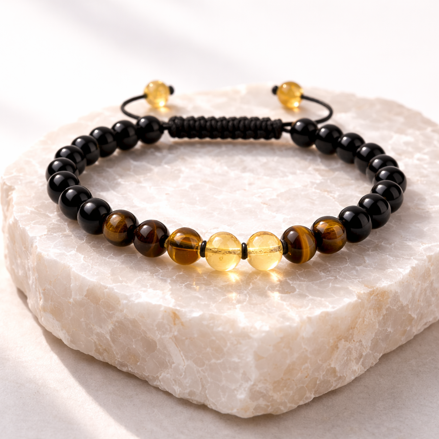 Black onyx, tiger’s eye and citrine crystal bracelet on stone base