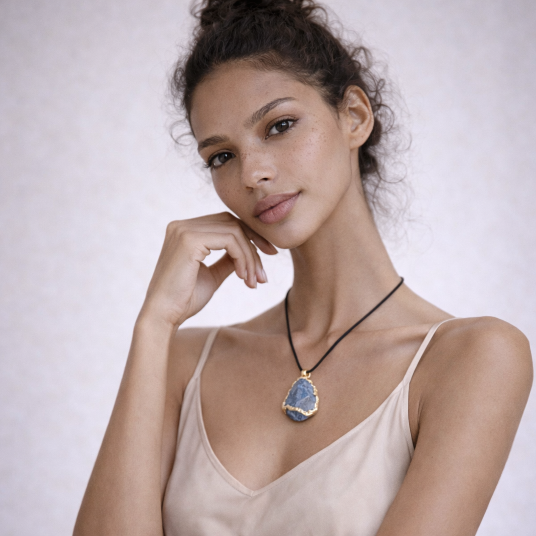 Blue apatite necklace worn on model close portrait with beige top