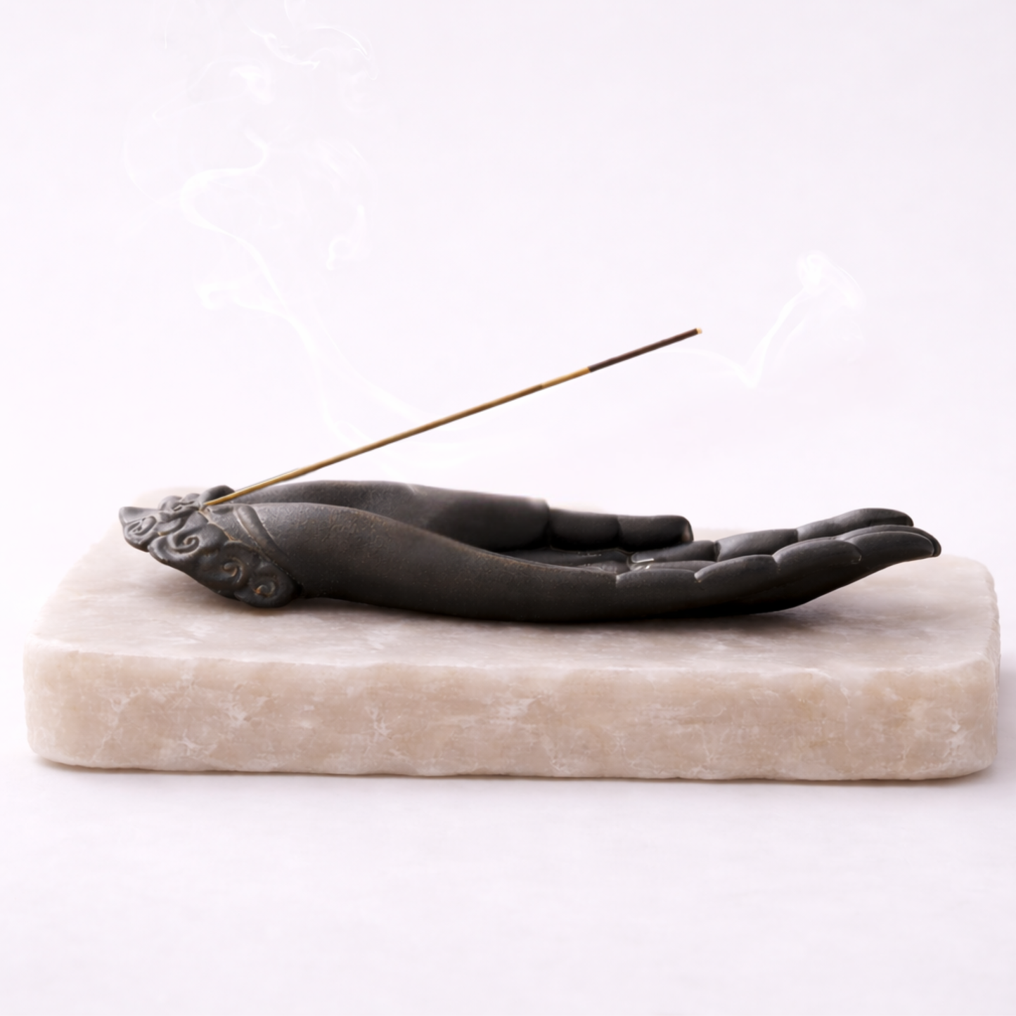 Buddha hand incense holder side profile on beige stone slab