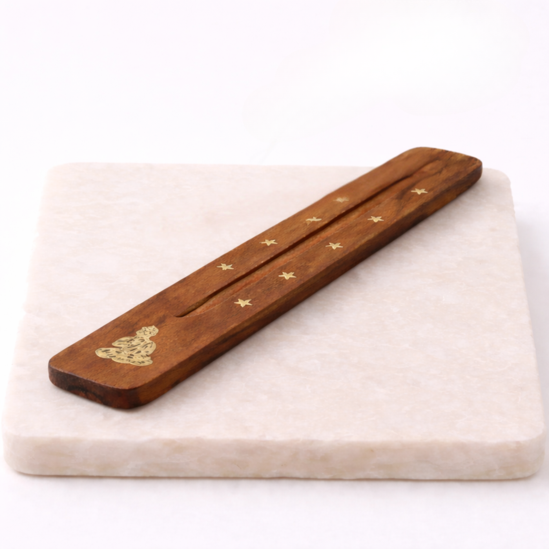 Buddha incense holder with incense stick on beige slab side angle
