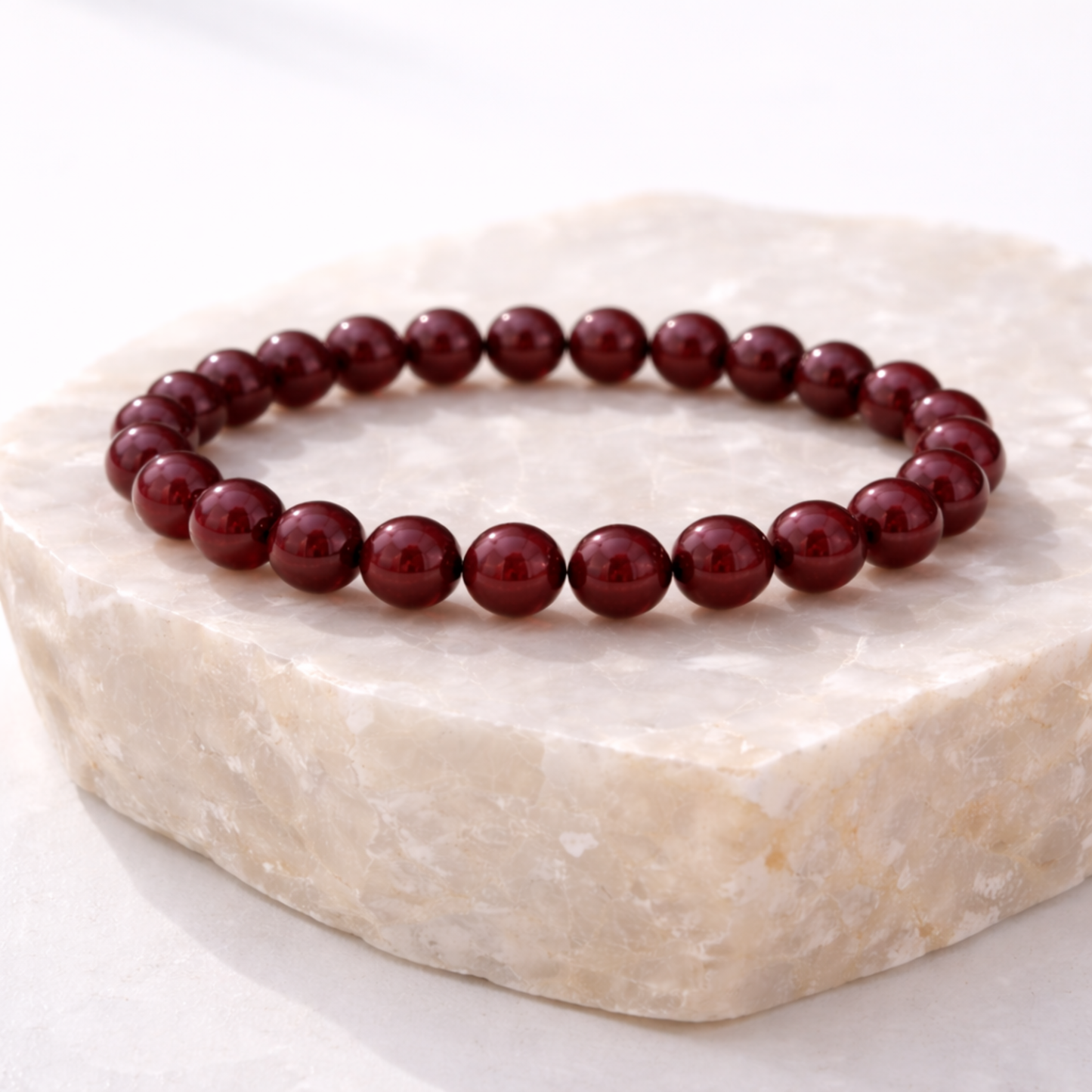 Cinnabar crystal bead bracelet displayed on natural stone