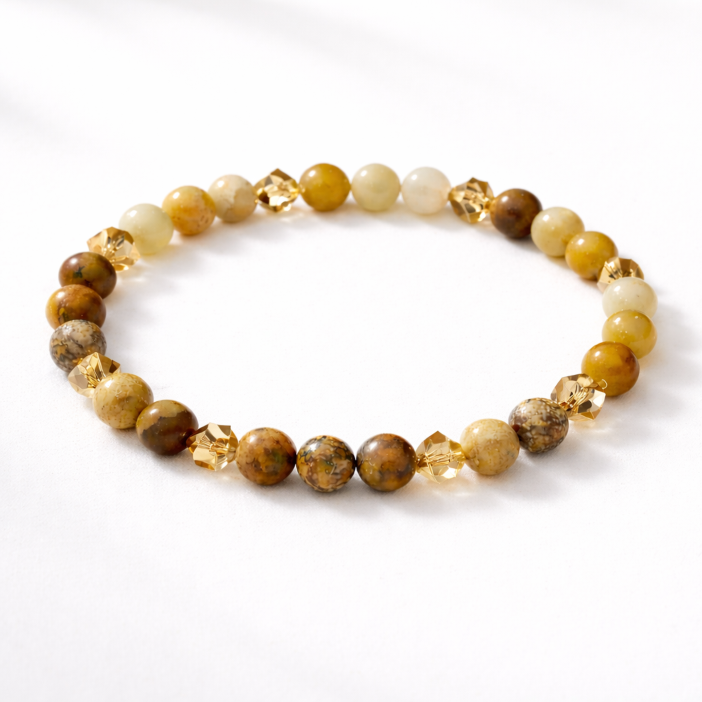 Citrine crystal bracelet with yellow and earth tone gemstone beads on white background