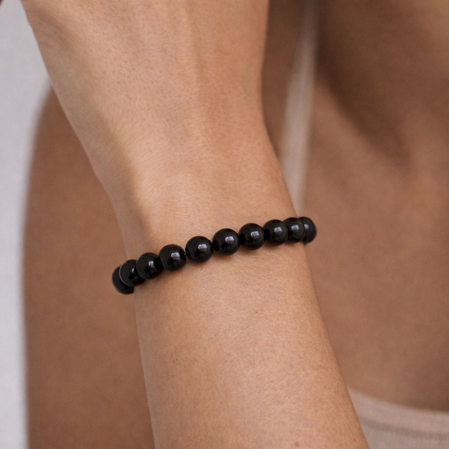 Close up of black obsidian bead bracelet on wrist