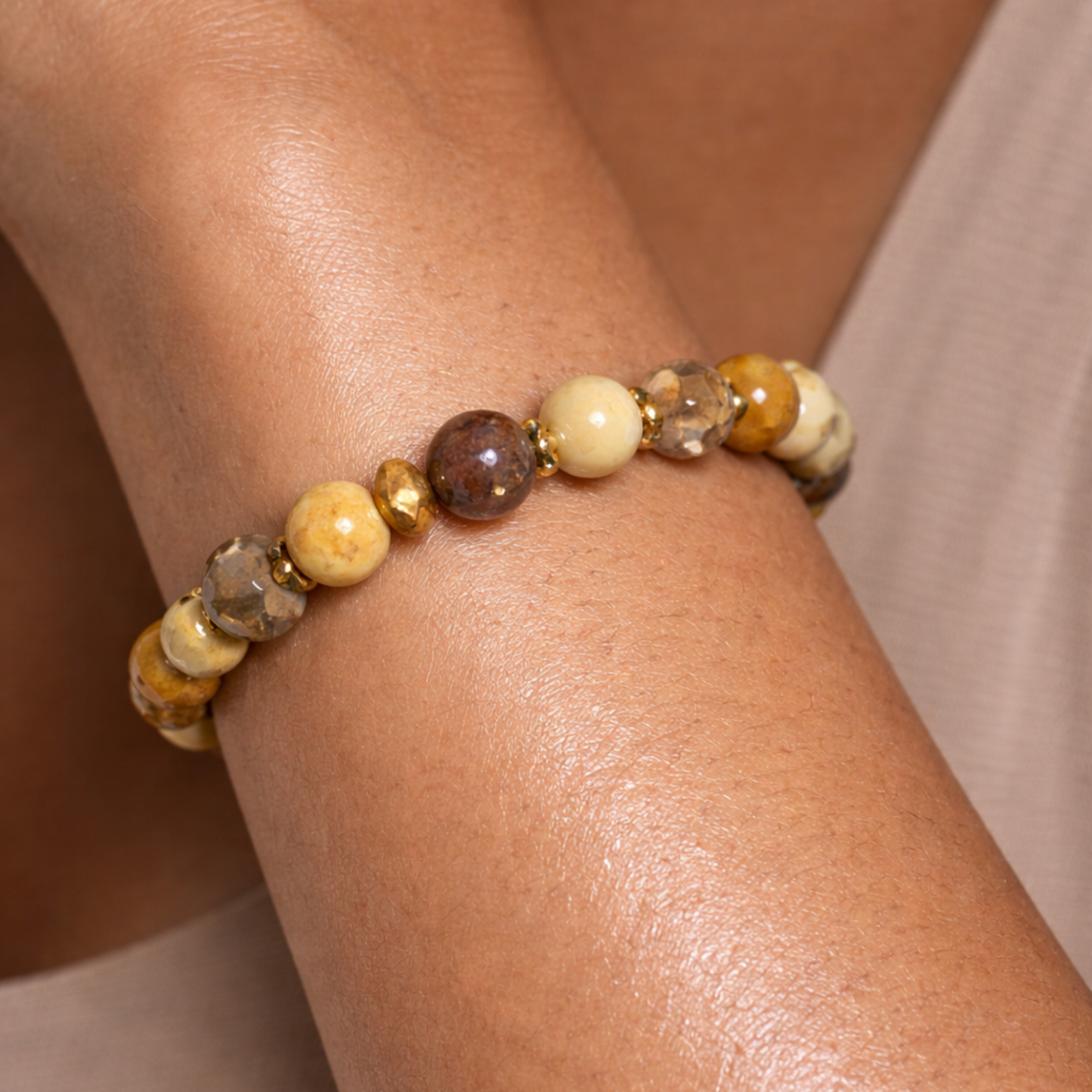 Close up of citrine gemstone bracelet worn on wrist with yellow and brown crystal beads