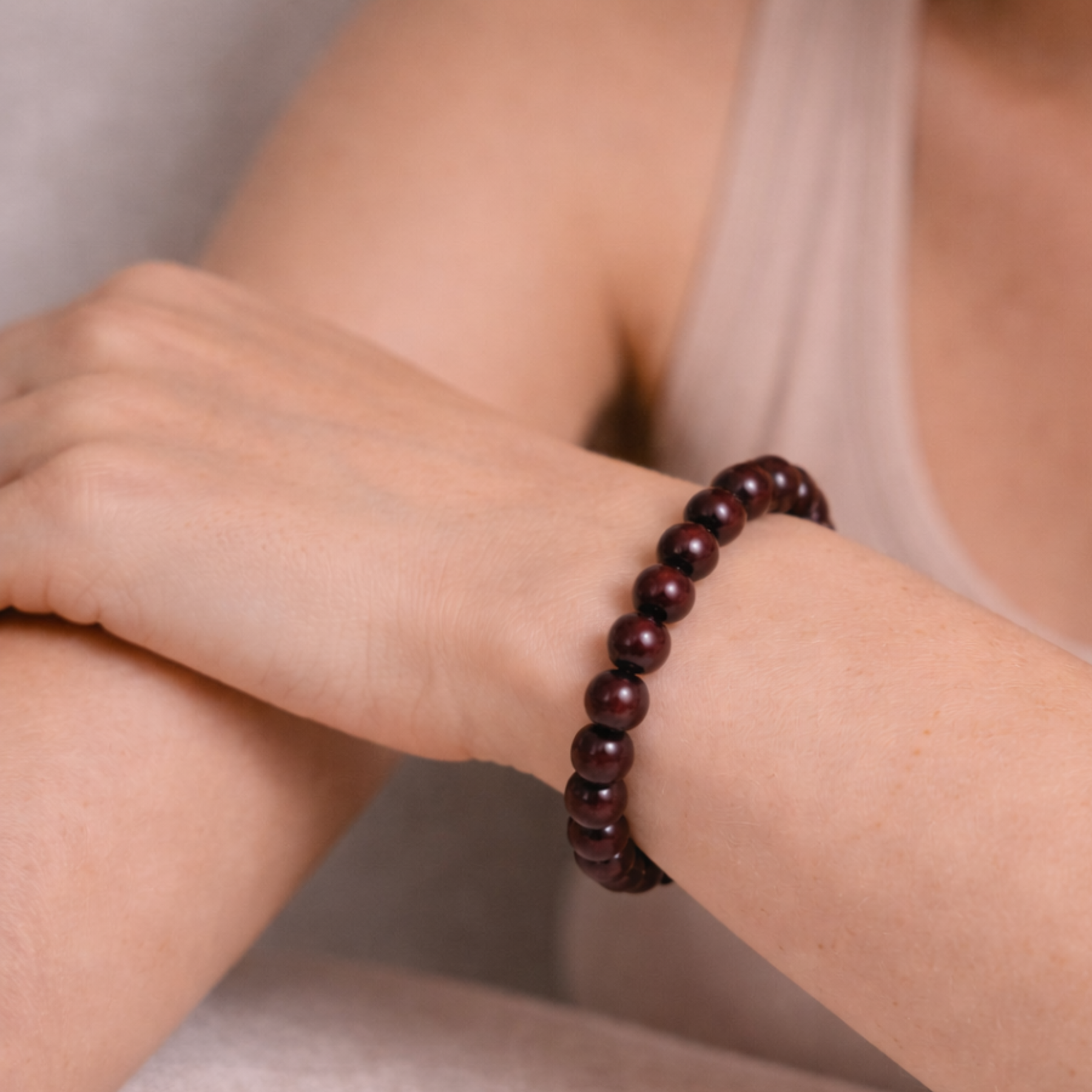 Close up of garnet crystal bead bracelet on wrist
