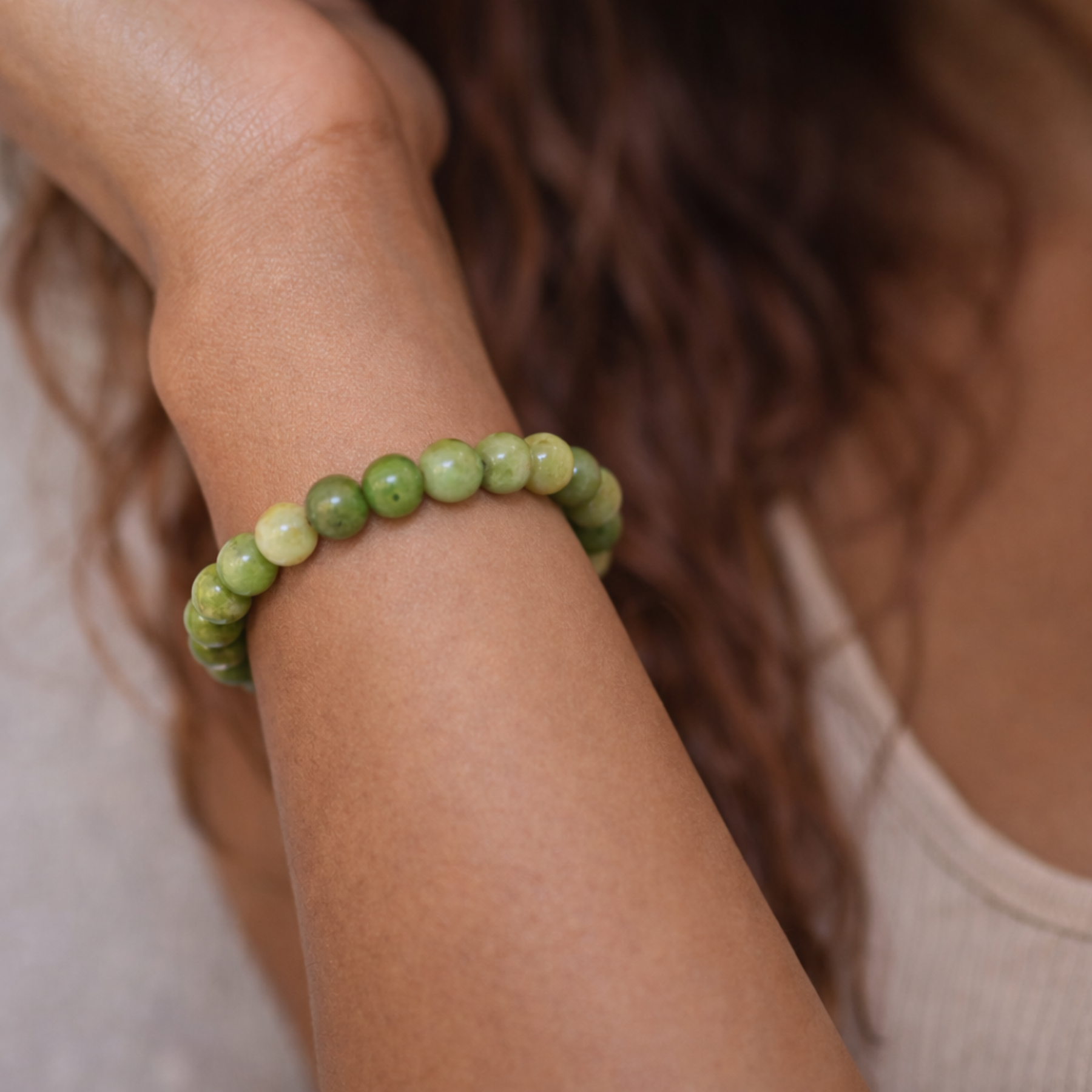 Close up of green jade bead bracelet on wrist