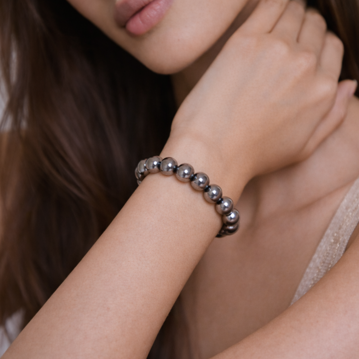 Close up of hematite bead bracelet worn on wrist