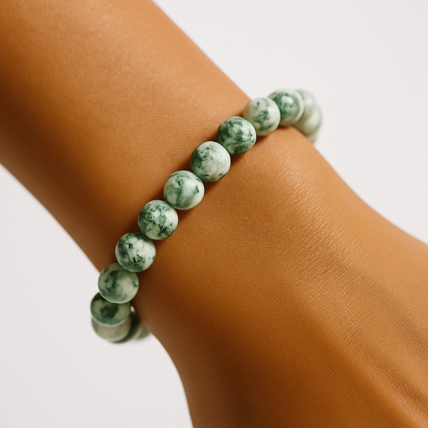 Close up of moss agate gemstone bracelet worn on wrist