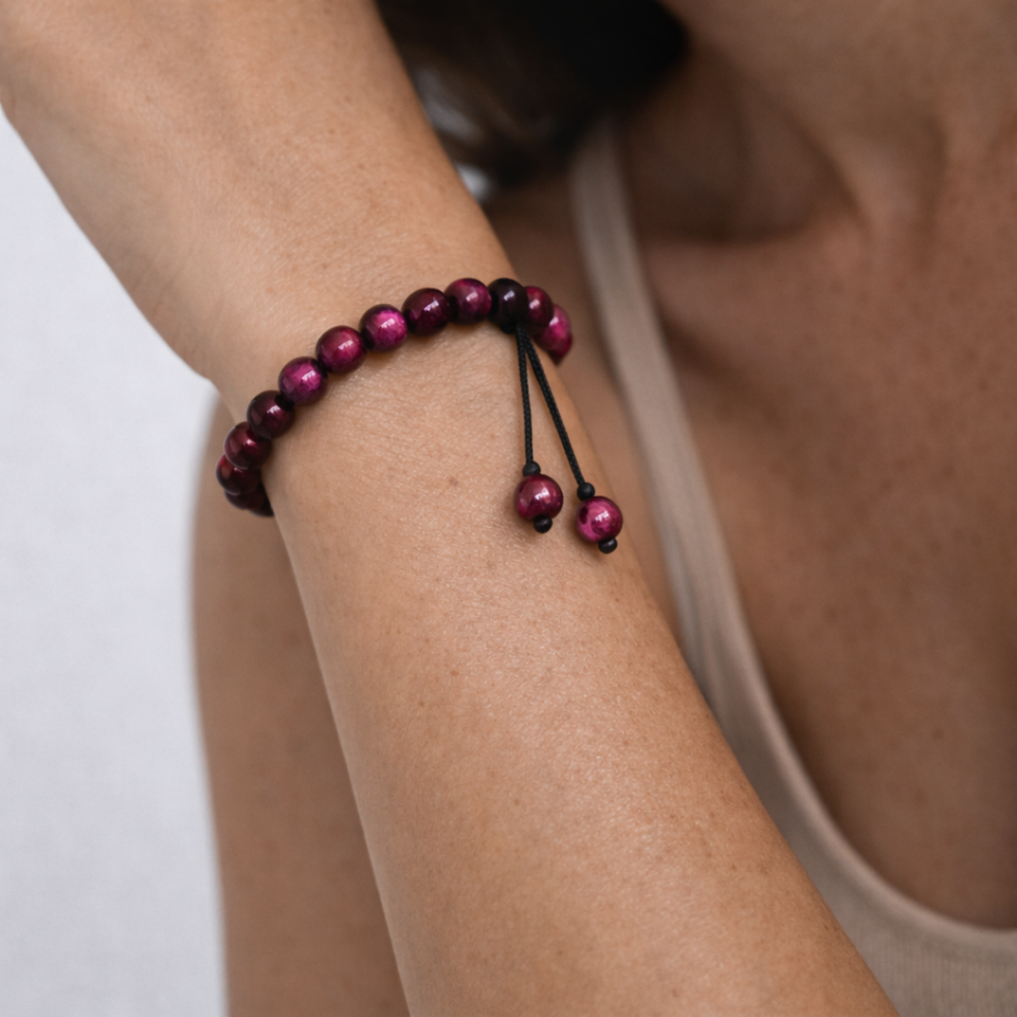 Close up of pink tiger’s eye adjustable cord bracelet on wrist