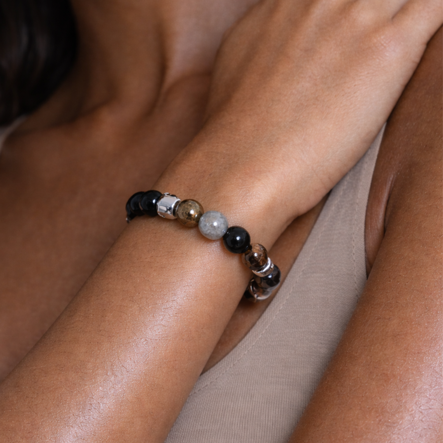 Close up of protection crystal bracelet worn on wrist with labradorite, pyrite, obsidian and smoky quartz