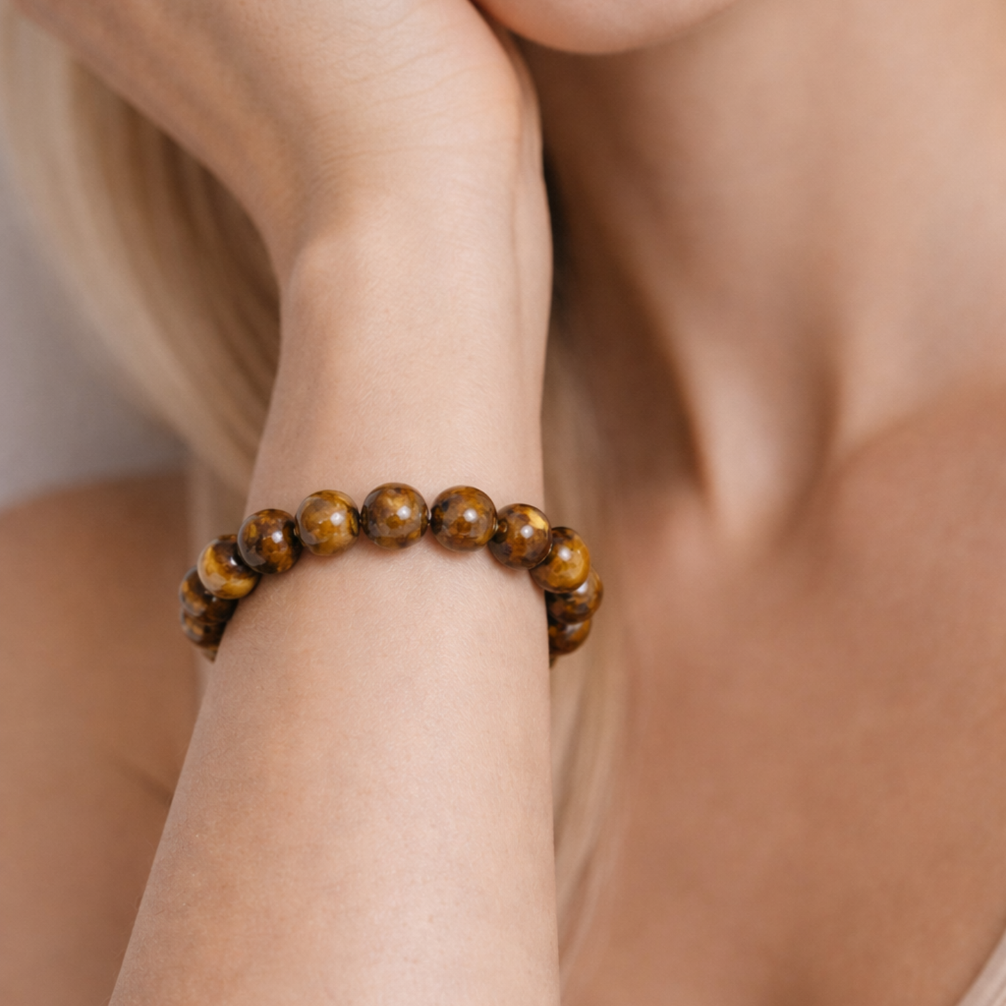 Close up of tiger’s eye crystal bracelet worn on wrist