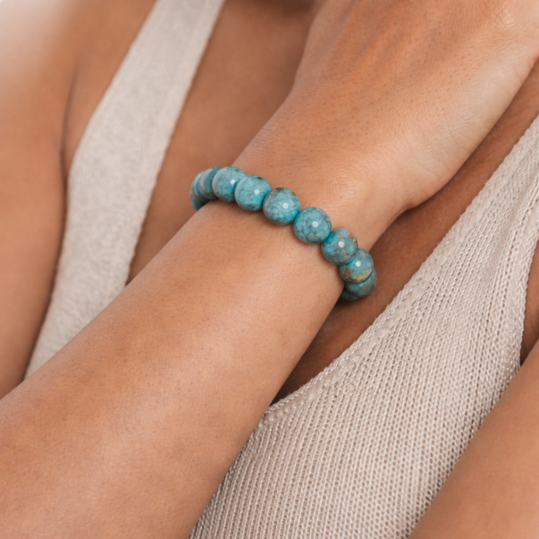 Close up of turquoise crystal bracelet worn on wrist