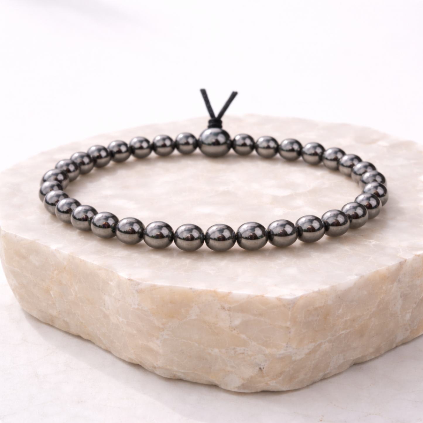 Hematite crystal bracelet on stone display base