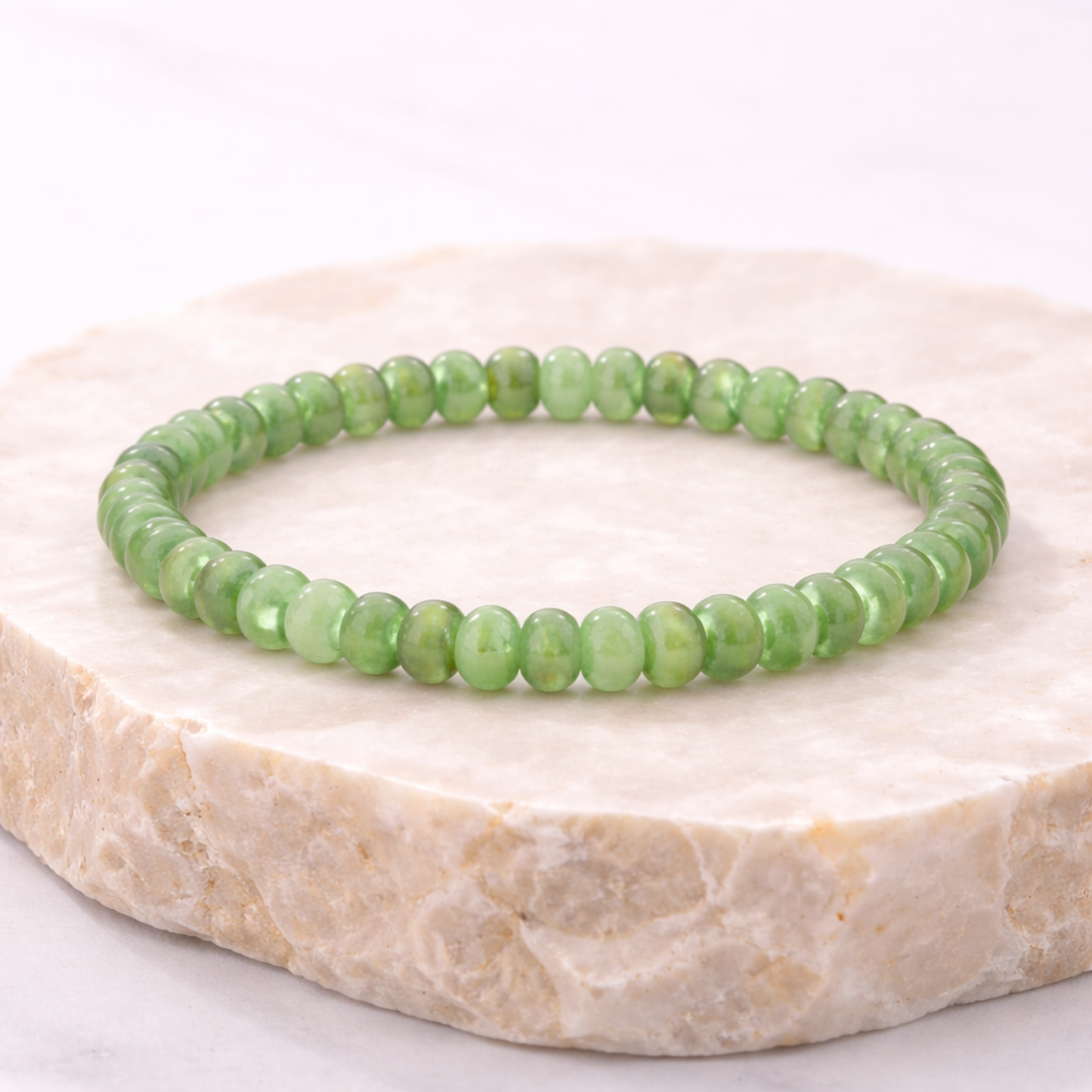 Jade bead bracelet on natural stone display