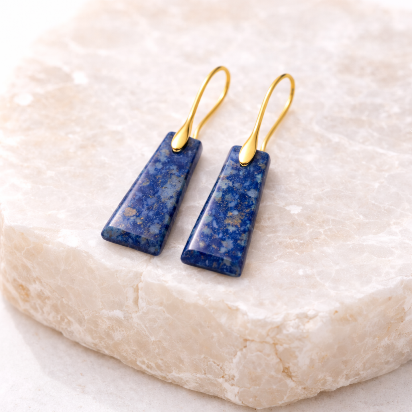 Lapis lazuli cut stone earrings on stone display