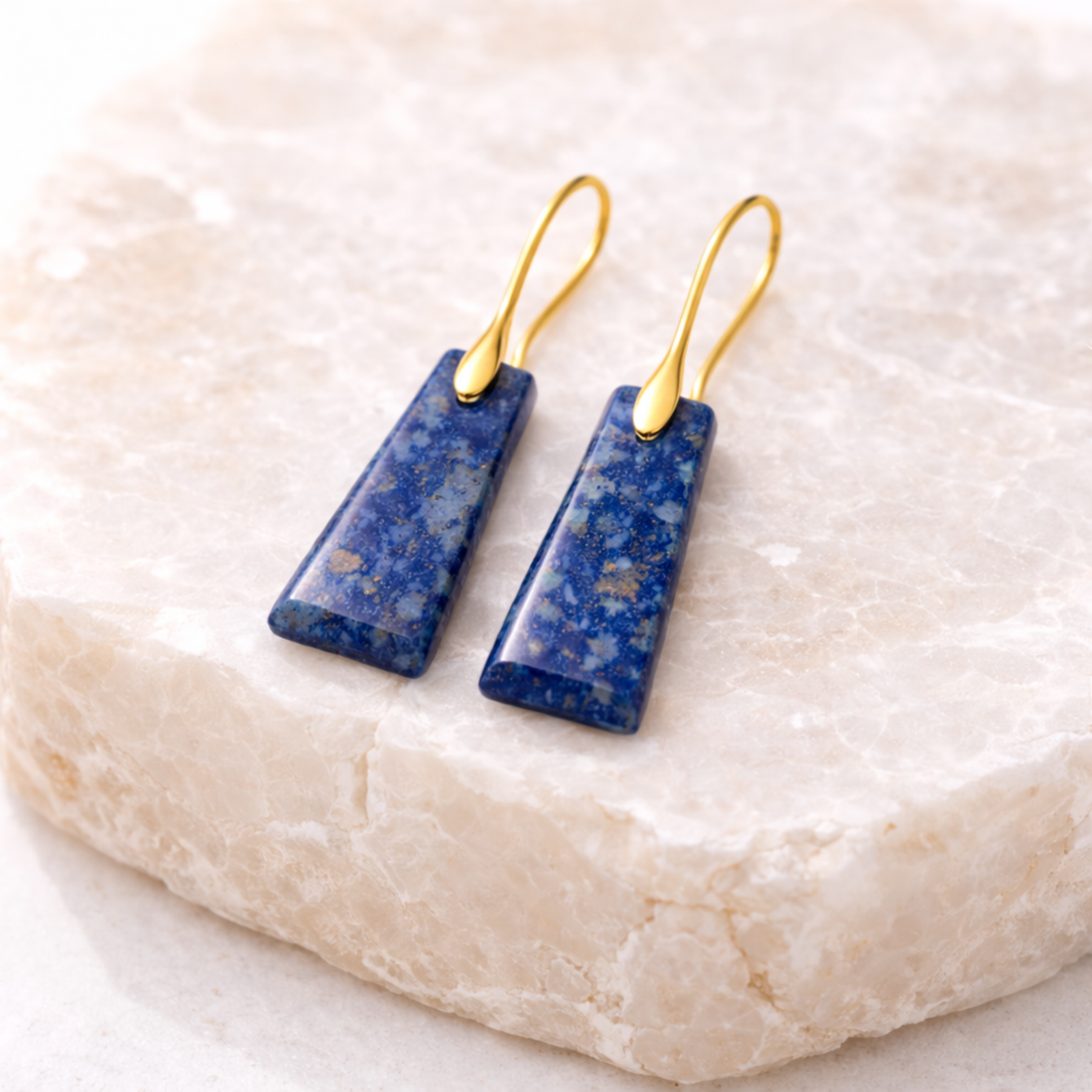 Lapis lazuli cut stone earrings on stone display