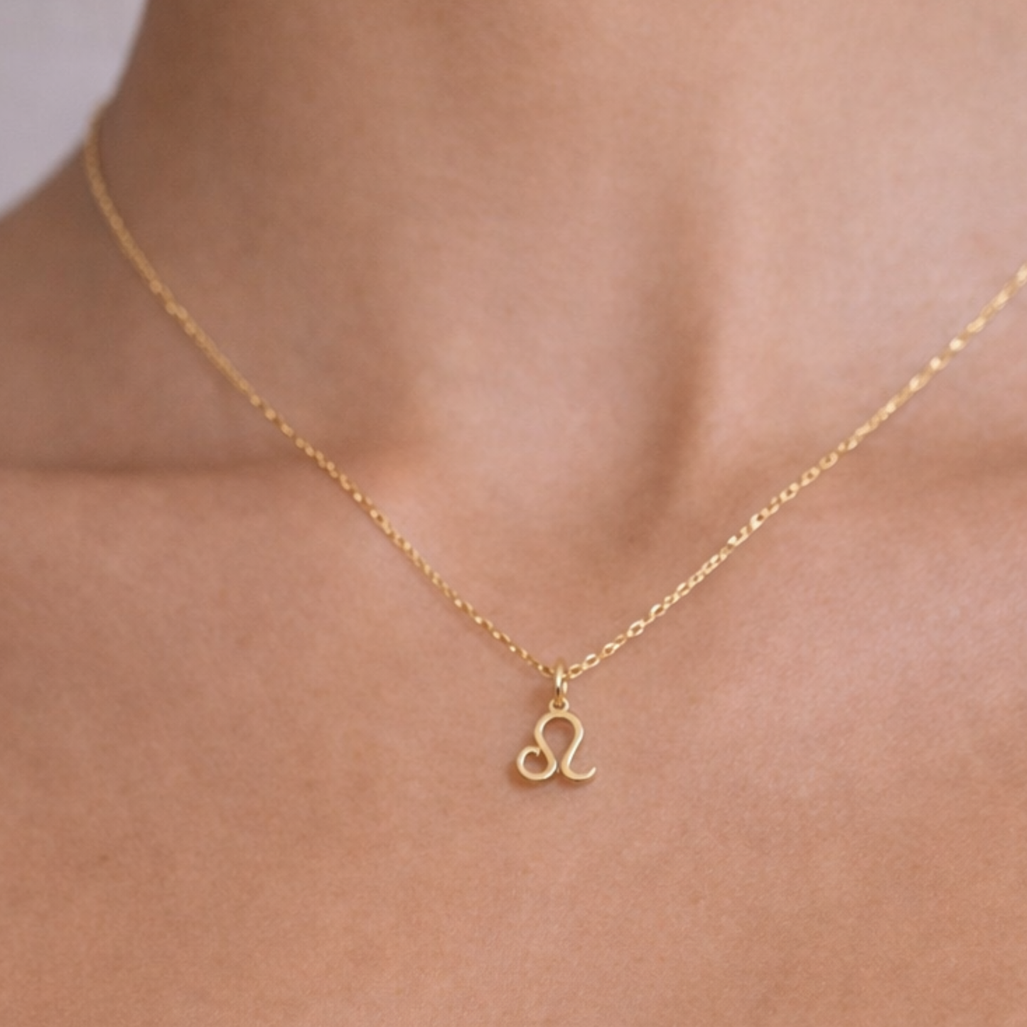 Leo zodiac necklace gold close up showing zodiac symbol pendant