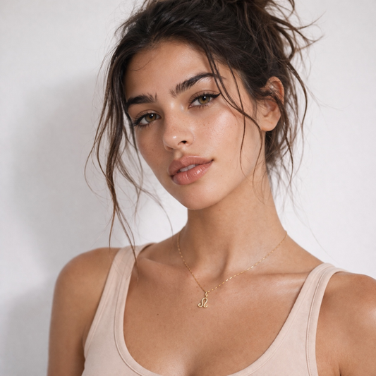 Leo zodiac necklace gold worn on model with beige top and gold chain