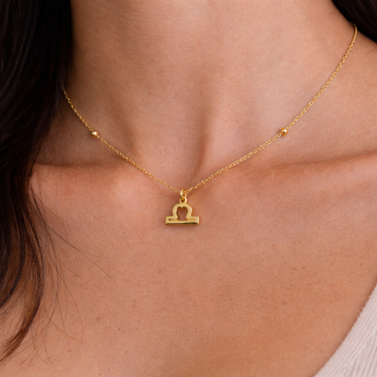 Libra zodiac necklace gold close up on model showing pendant