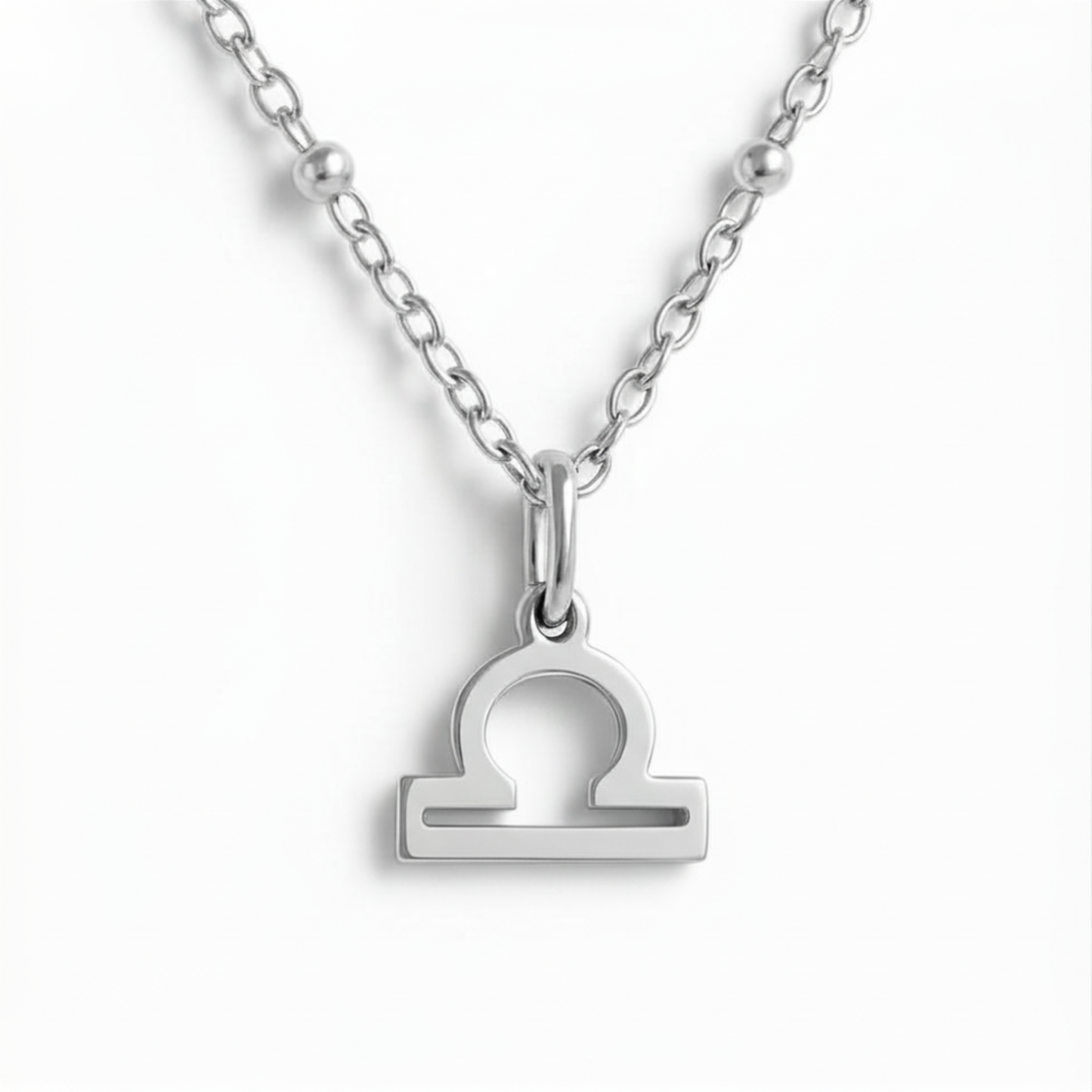 Libra zodiac necklace silver pendant on silver chain close up