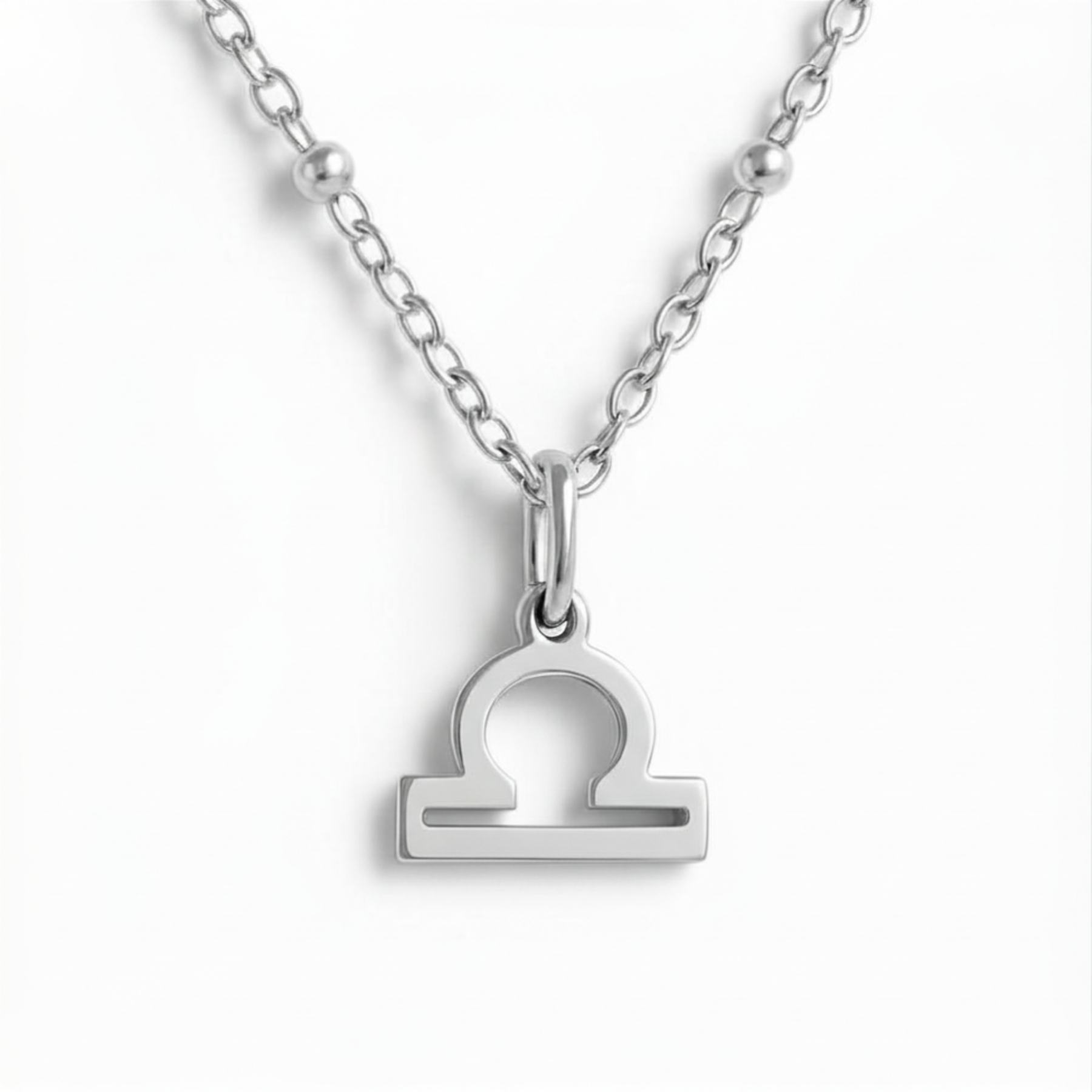 Libra zodiac necklace silver pendant on silver chain close up