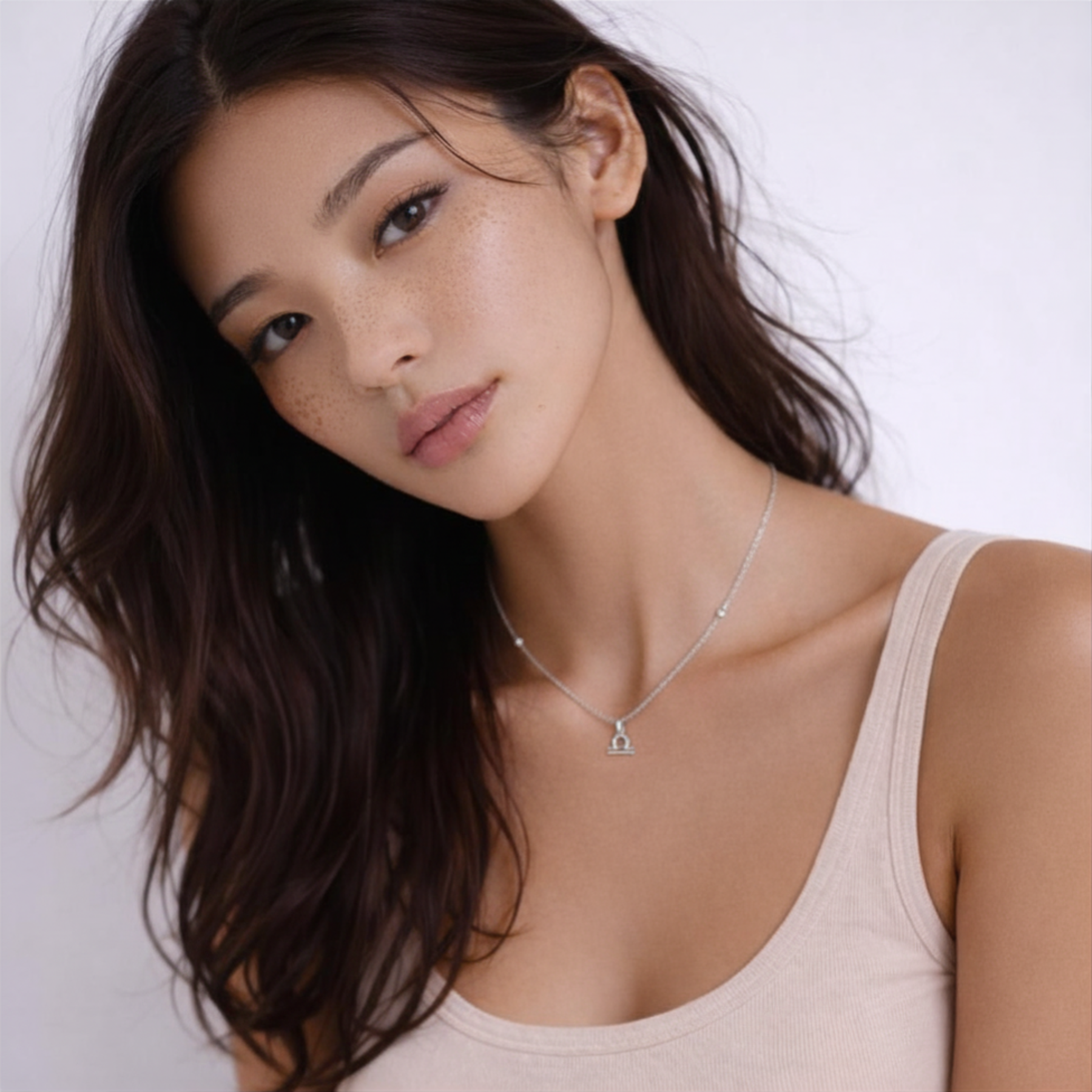 Libra zodiac necklace silver worn on model looking to the side