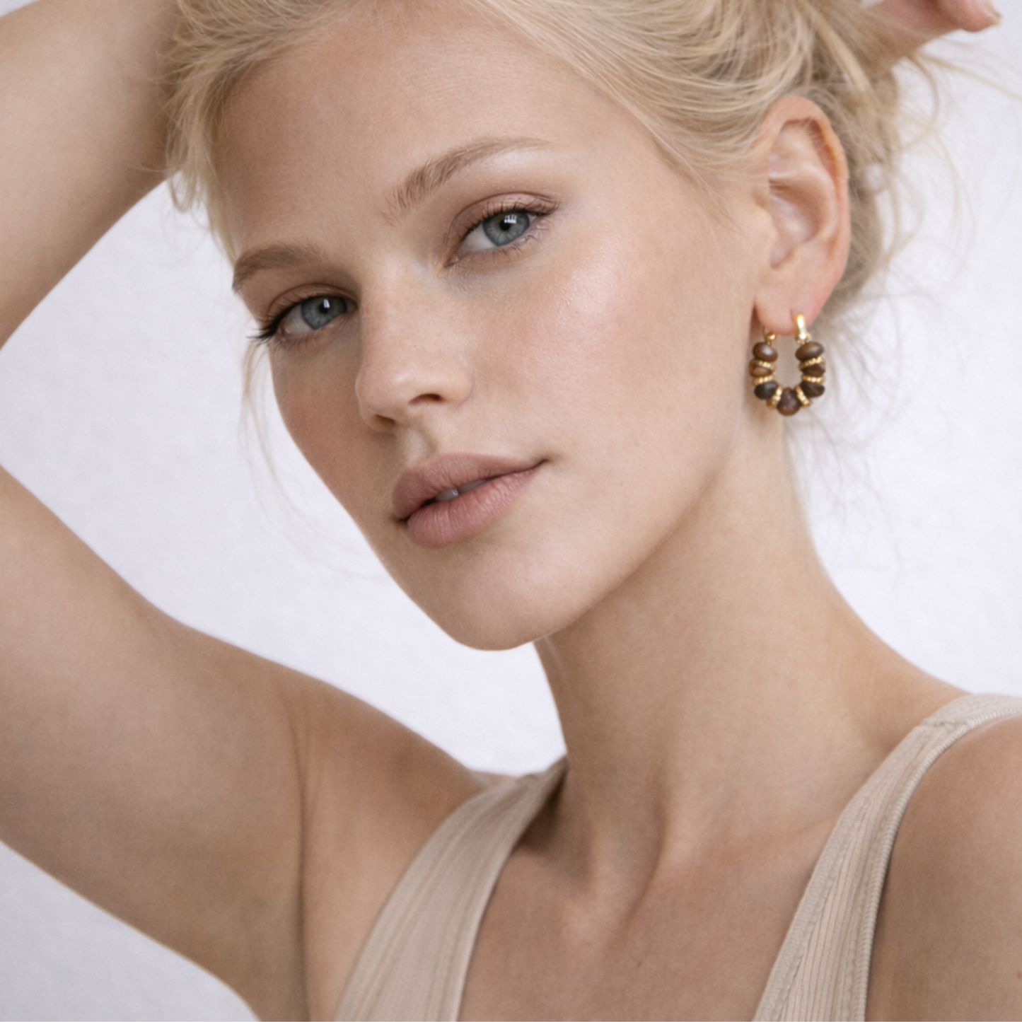 Model wearing Tiger’s Eye crystal hoop earrings