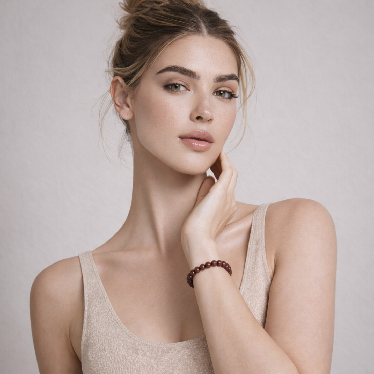 Model wearing cinnabar crystal bracelet styled with neutral outfit