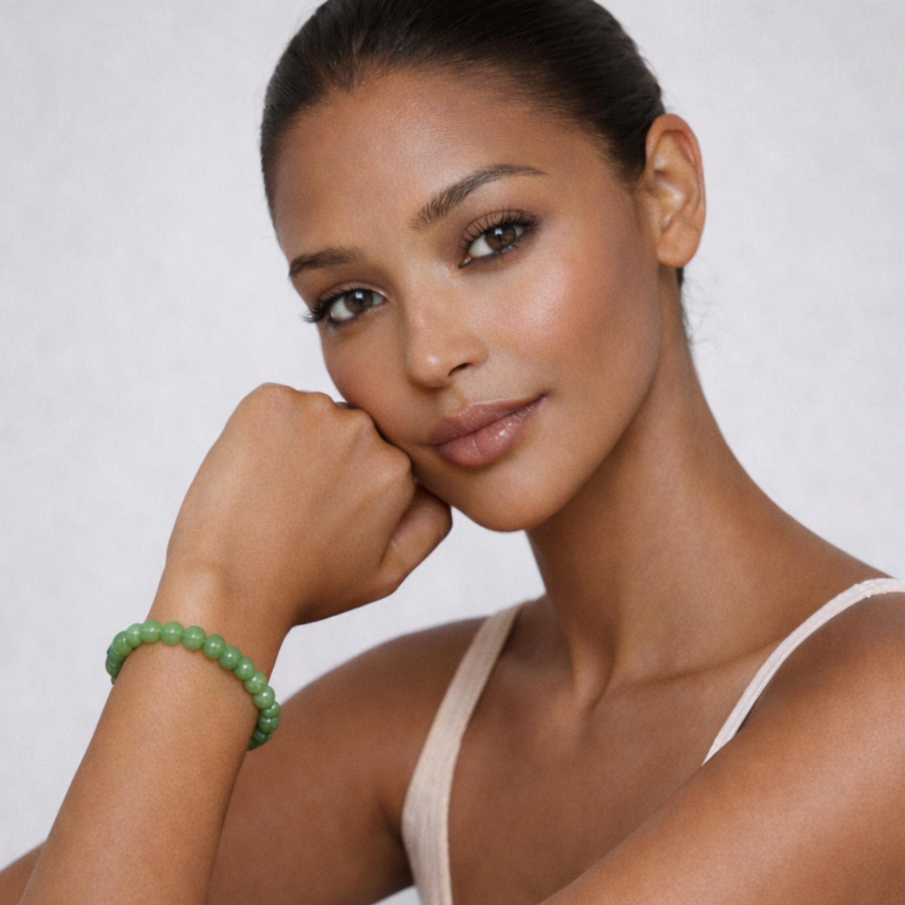 Model wearing emerald green jade bracelet