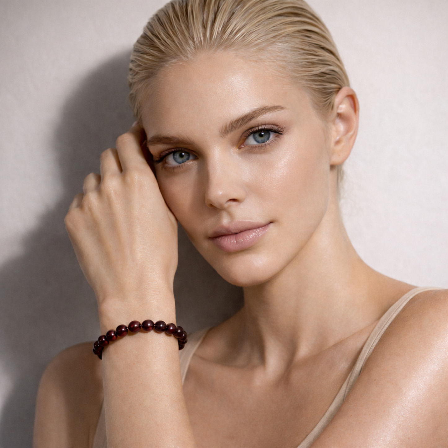 Model wearing garnet crystal bead bracelet on wrist