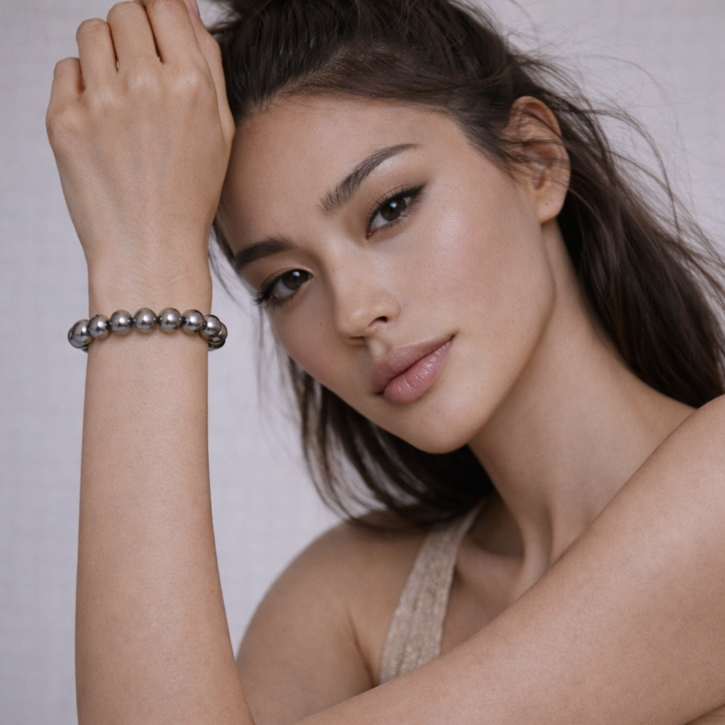Model wearing hematite crystal bracelet for grounding and protection