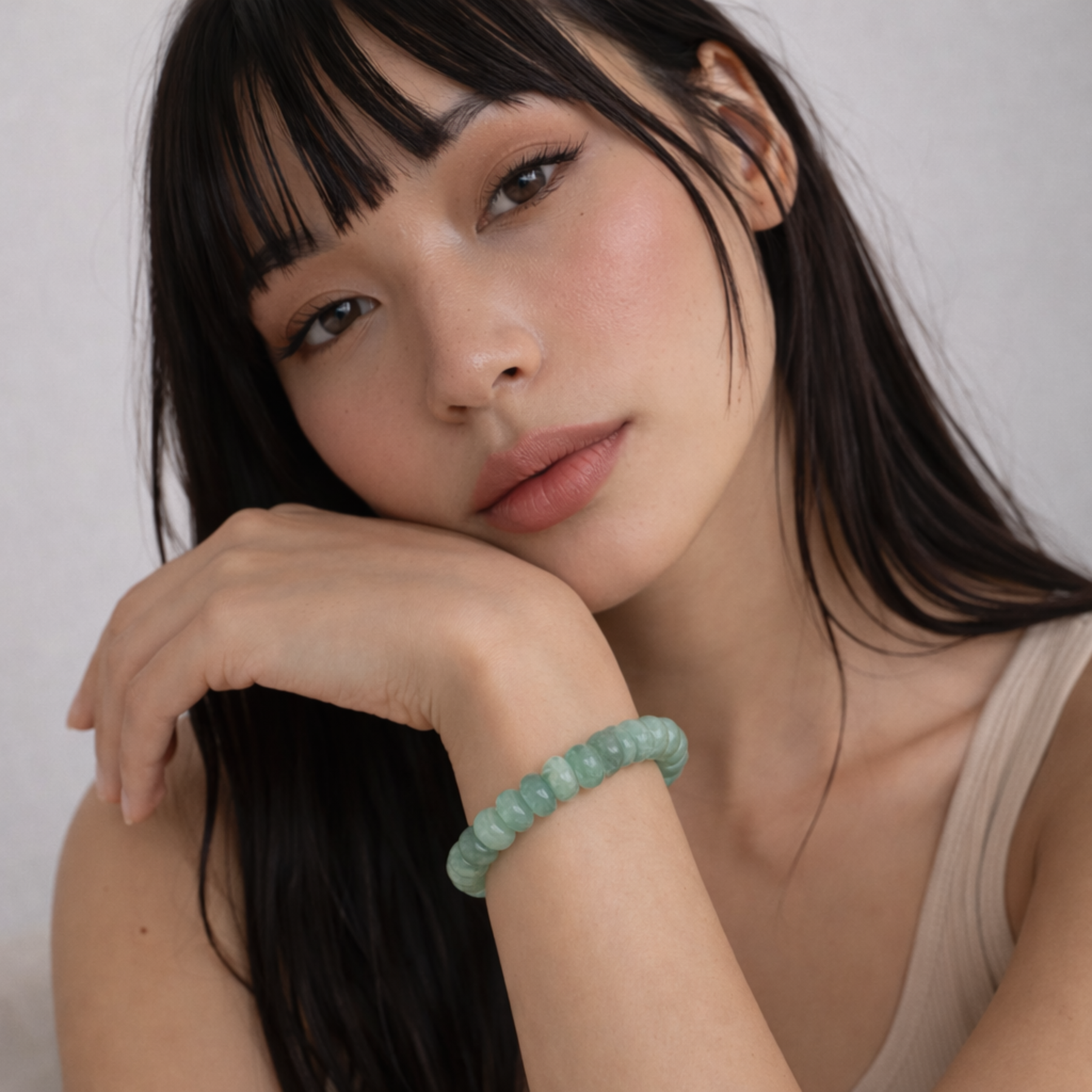 Model wearing jade bead bracelet