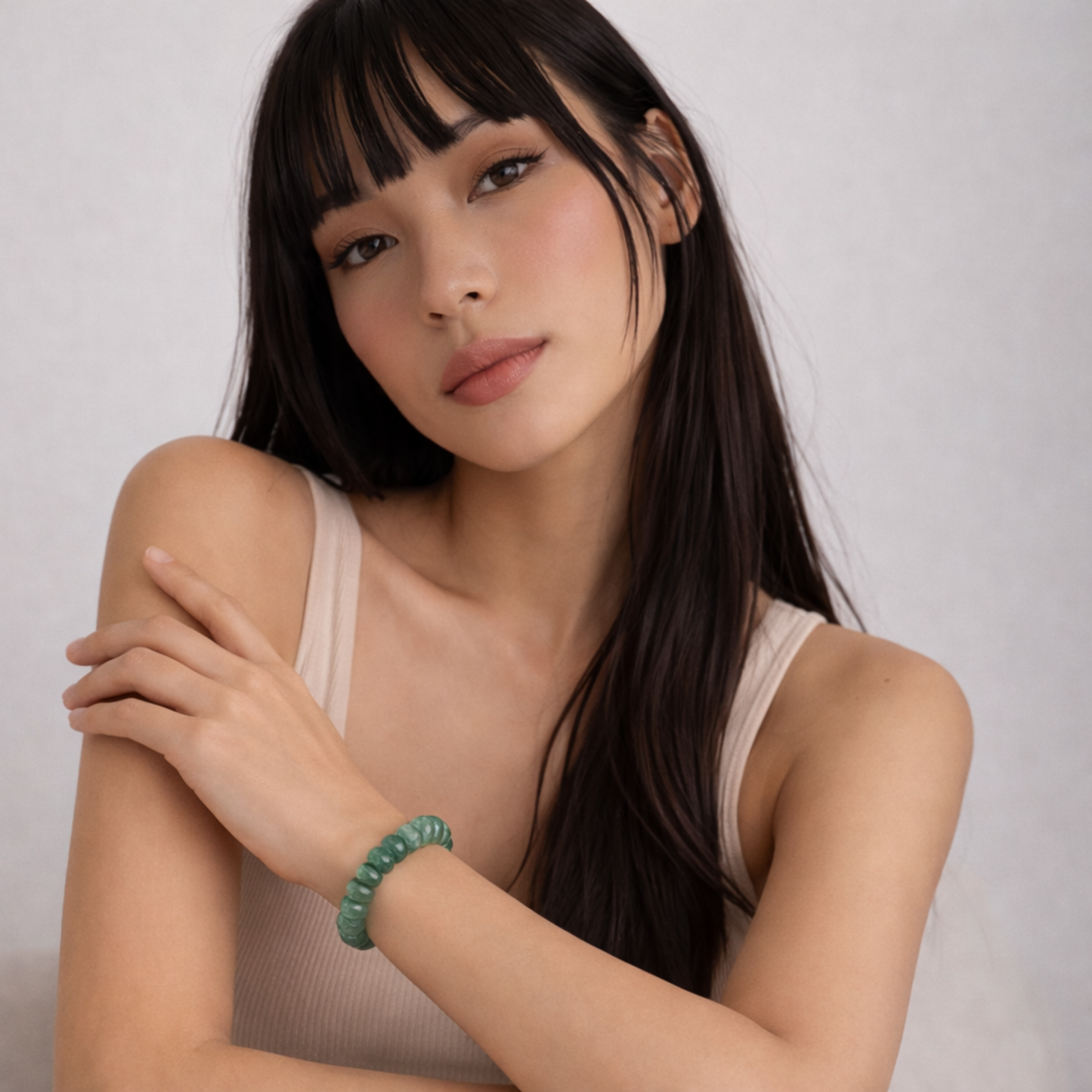 Model wearing jade bead bracelet close up