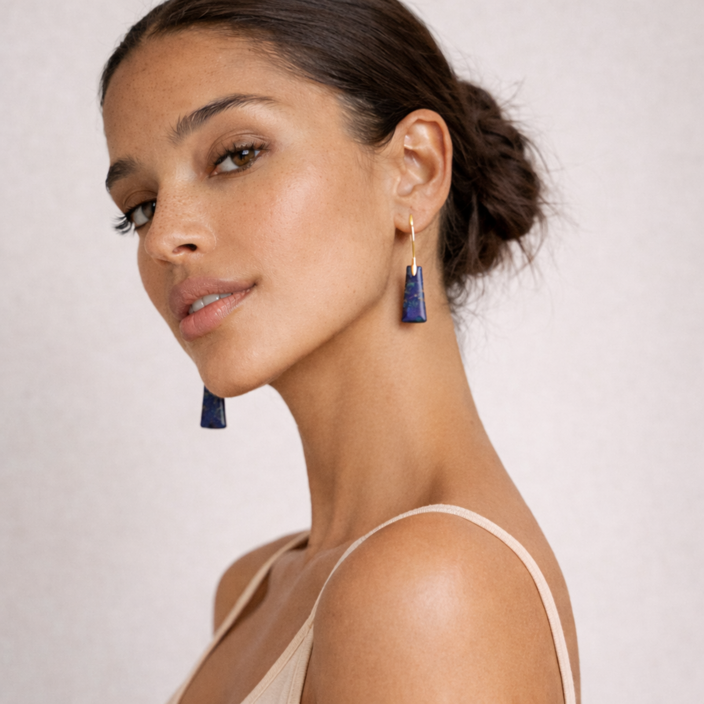 Model wearing lapis lazuli cut stone earrings