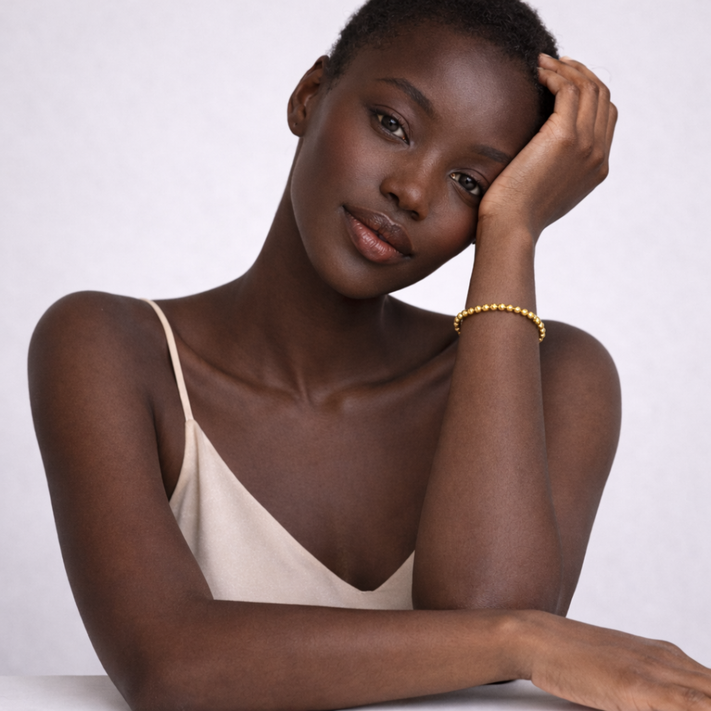 Model wearing pyrite bead bracelet on wrist
