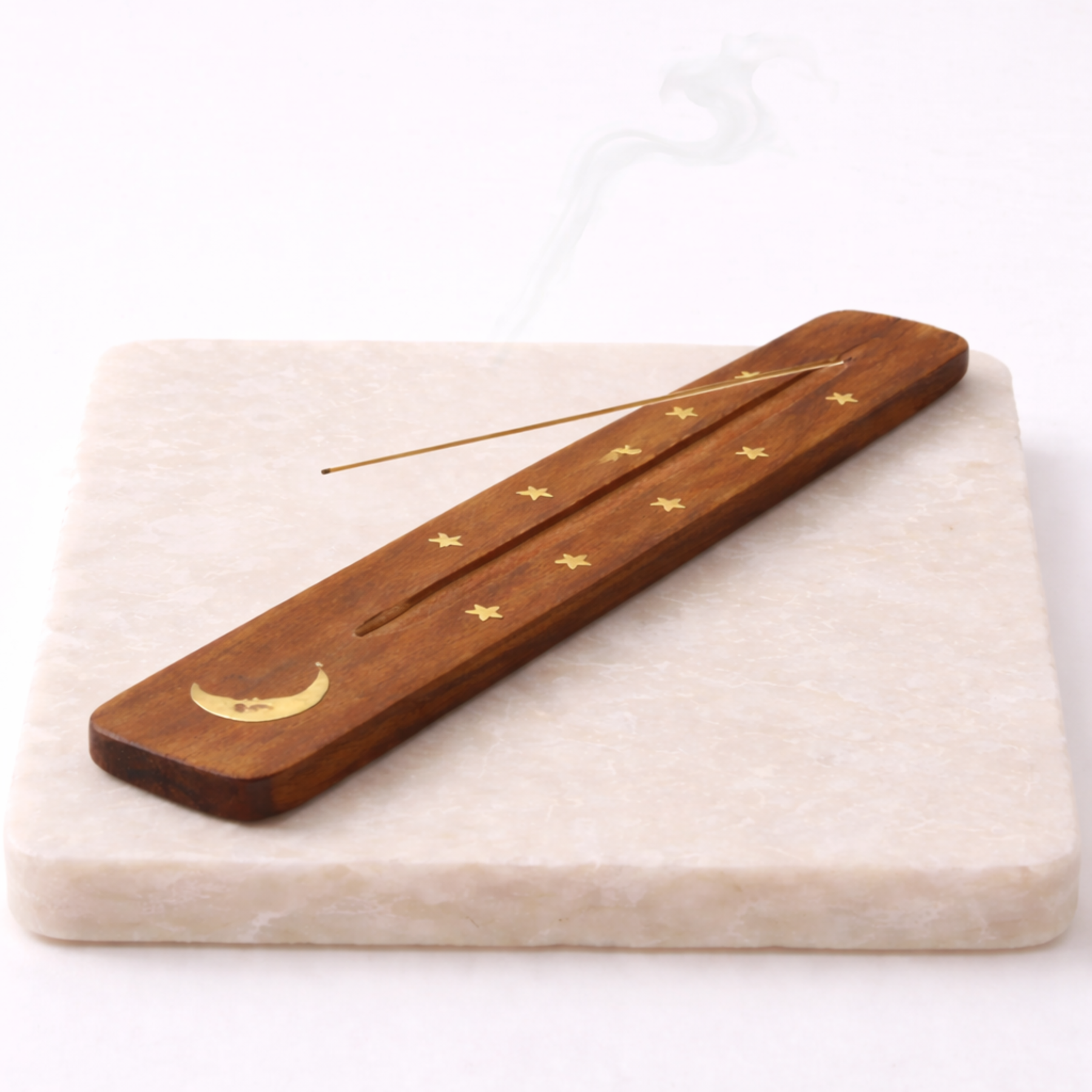Moon incense holder with incense stick on beige stone slab natural wood